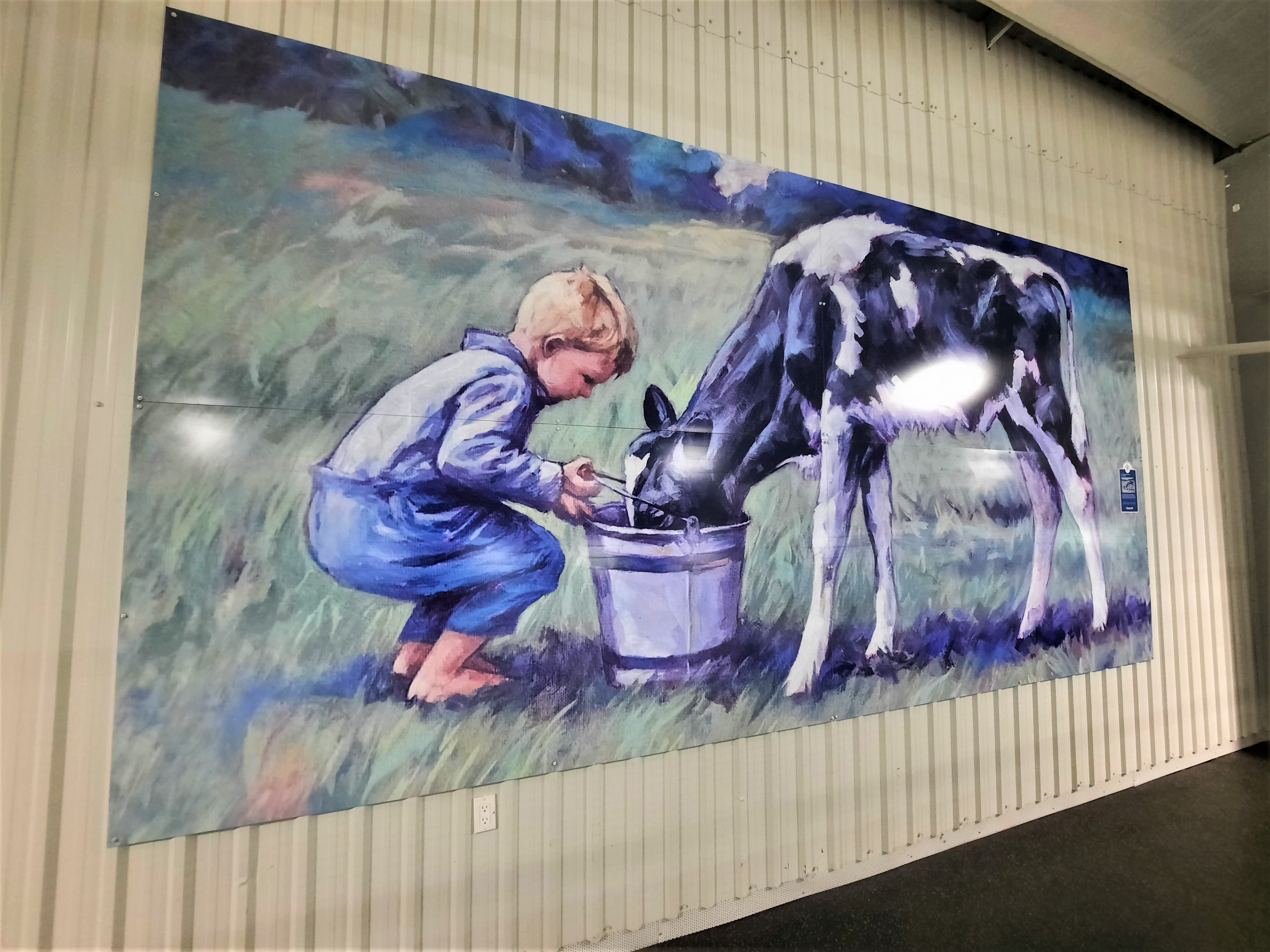 Painting of young boy feeding calf